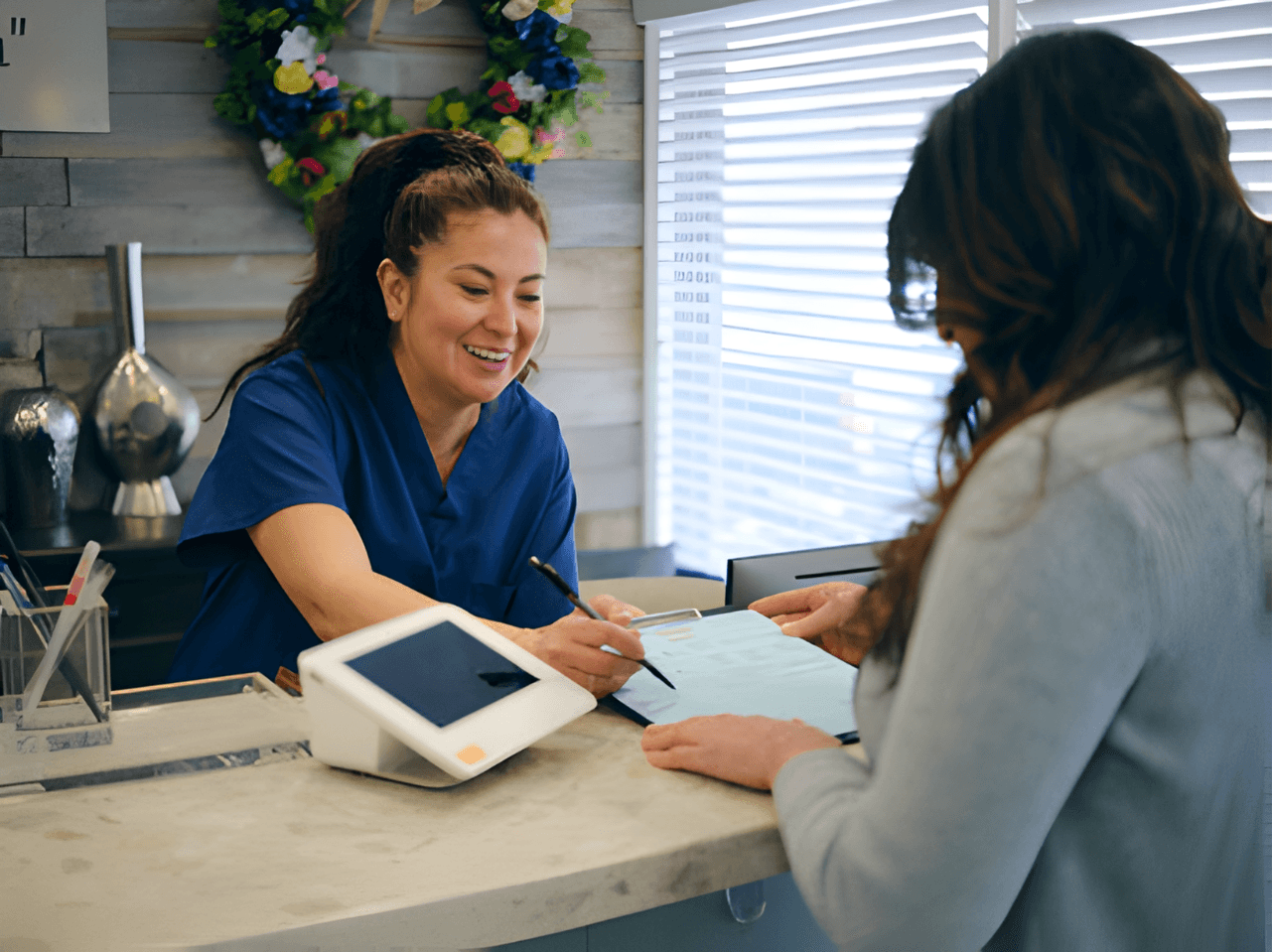 Patient and staff in a healthcare practice. Streamlined payments with Payment Bridge via Croft