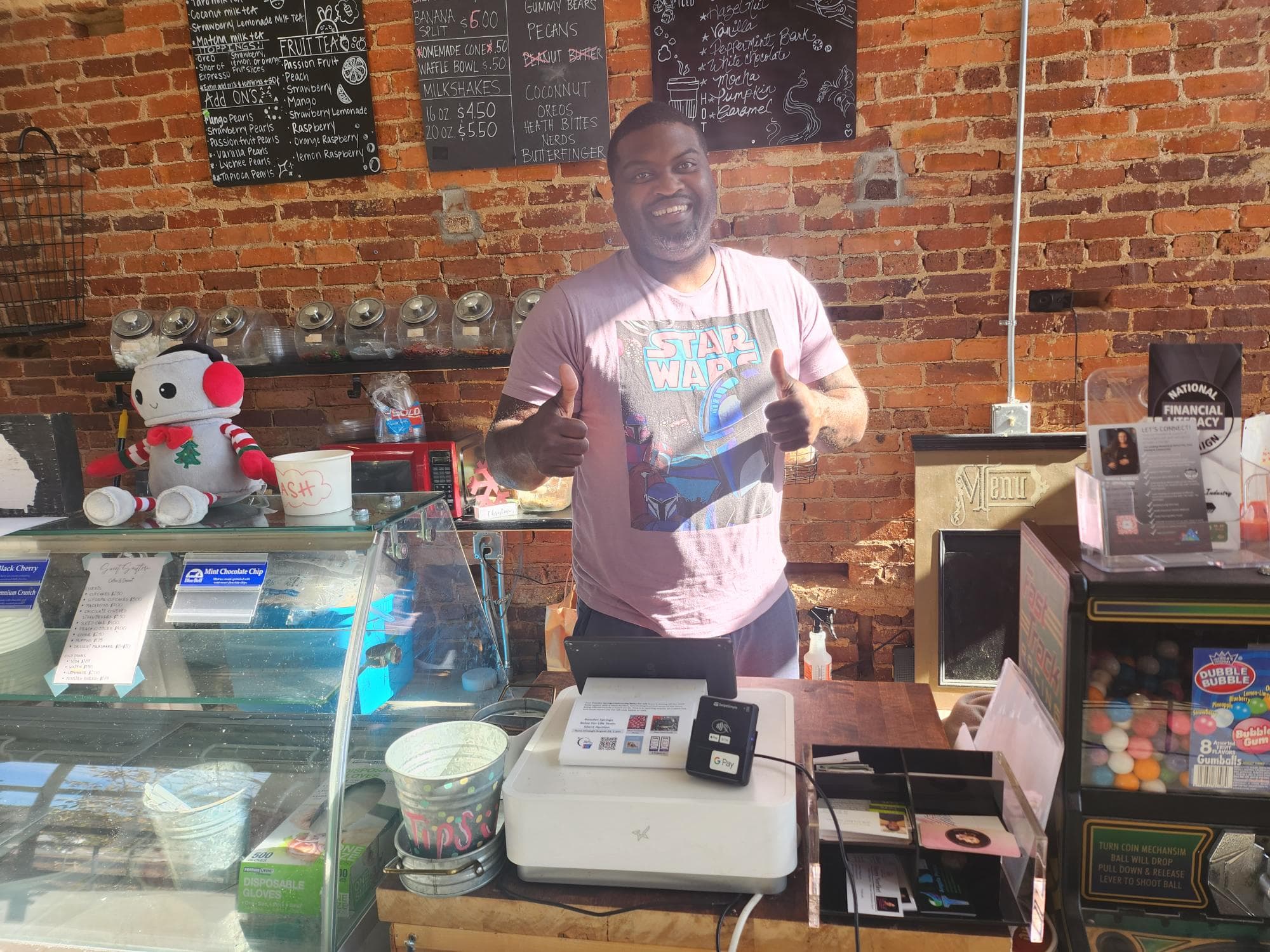 Local merchant behind counter with POS, happy with Croft rewards program